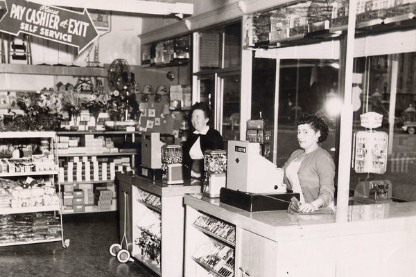 Cashiers standing at the front checkout at Keans Store Co in 1950.
